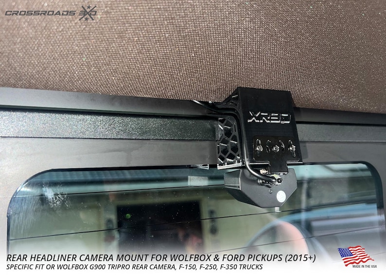 May include: Black rear headliner camera mount for Wolfbox and Ford pickups. The mount is attached to the vehicle's headliner and includes the text "XRE3". The image also includes the text "REAR HEADLINER CAMERA MOUNT FOR WOLFBOX & FORD PICKUPS (2015+)".