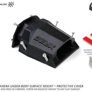 Peut inclure: Support de surface et protection de caméra Wolfbox noir. Comprend un adhésif double face automobile et des vis en acier inoxydable. Protège les caméras Wolfbox G9. Le texte "CBX" est visible.