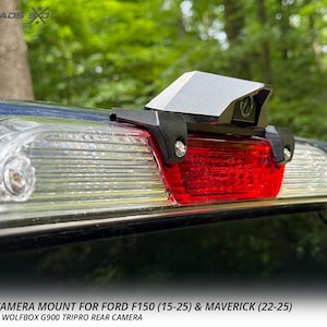 以下が含まれることがあります： フォードF150 (15-25) およびマベリック (22-25) トラック用の黒いWolfboxカメラマウント。マウントは赤いブレーキライトの上に設置されています。アメリカ製です。