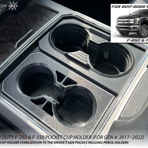 May include: Black pocket cup holder for Ford Super Duty F-250 & F-350 trucks. The cup holder includes pencil holders and adds stabilization to the driver's side pocket. The text on the image says "FOR 2017-2022 SUPER DUTY F-250 & F-350".