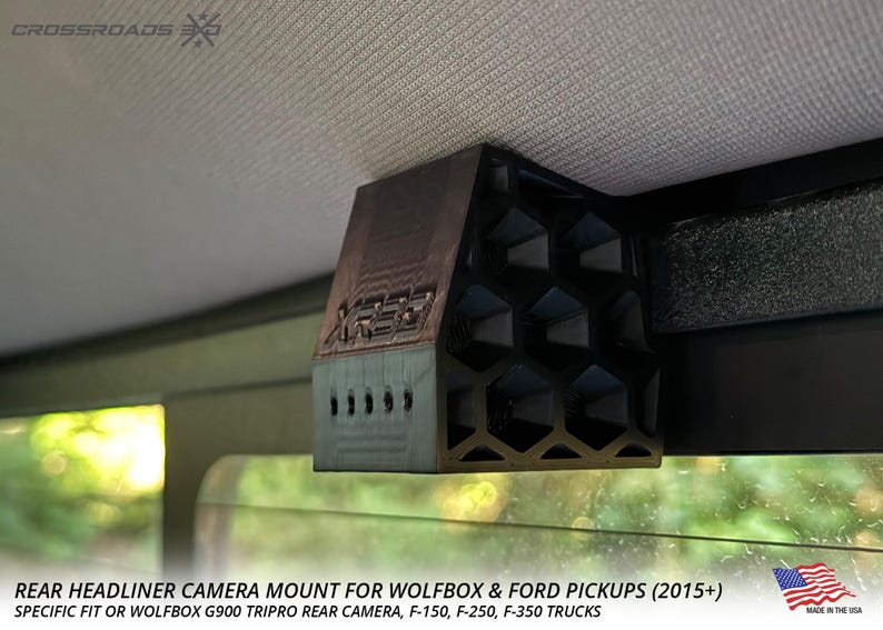 May include: A black and brown rear headliner camera mount with a honeycomb design. The mount is designed for Wolfbox and Ford pickup trucks. The text "CROSSROADS" is visible at the top left.