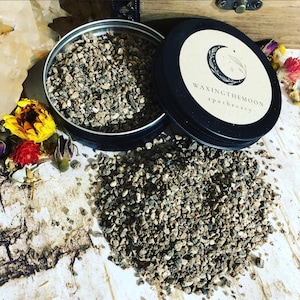 May include: A handmade wooden sign with the text "Welcome" in a playful font. The sign is painted white with a distressed finish, and features a decorative floral design in shades of pink and green. It measures approximately 12 inches wide.