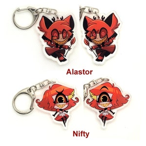 Puede incluir: Dos juegos de llaveros con personajes de dibujos animados de la serie animada Hazbin Hotel. El primer juego presenta al personaje Alastor, un demonio rojo con cuernos, una amplia sonrisa y un atuendo rojo y negro. El segundo juego presenta al personaje Niffty, un demonio rojo con un solo ojo grande, una amplia sonrisa y un vestido rojo y blanco.