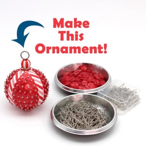 May include: Make This Ornament!  A red and white striped Christmas ornament covered in red sequins.  Two bowls, one with red sequins and one with silver pins.