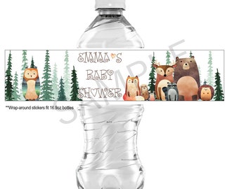 May include: A water bottle with a wrap-around label featuring forest animals and the text "Emma's Baby Shower." The design includes an owl, fox, bear, deer, and other woodland creatures. The label is designed to fit 16.9oz bottles.
