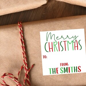 May include: A white gift tag with green and red lettering that says "Merry Christmas". The tag has spaces to write "To:" and "From:". The tag says "From: The Smiths".