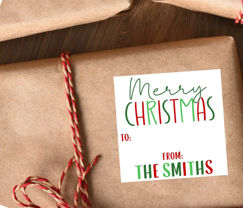 May include: A white gift tag with green and red lettering that says "Merry Christmas". The tag has spaces to write "To:" and "From:". The tag says "From: The Smiths".