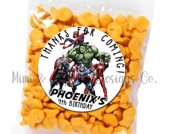 May include: A white circle sticker with a black border and text that says "Thanks for coming! Phoenix's 4th Birthday". The sticker features a group of superheroes from the Marvel universe, including Spiderman, Hulk, Thor, Captain America, and Iron Man.