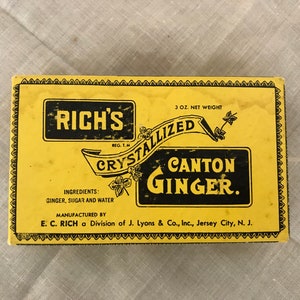 May include: A yellow box with black lettering that reads "RICH'S REG. T.M. CRYSTALLIZED CANTON GINGER." The box is 3 ounces and contains crystallized ginger. The ingredients are listed as ginger, sugar, and water. The box is manufactured by E.C. RICH a Division of J. Lyons & Co., Inc., Jersey City, N.J.
