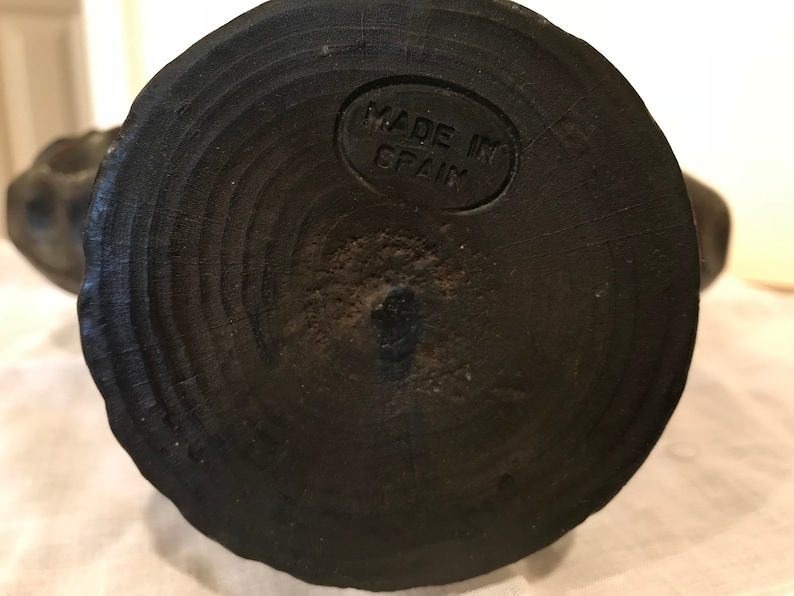 Puede incluir: La parte inferior de una escultura de madera con una base circular. La base est&aacute; marcada con "MADE IN SPAIN".