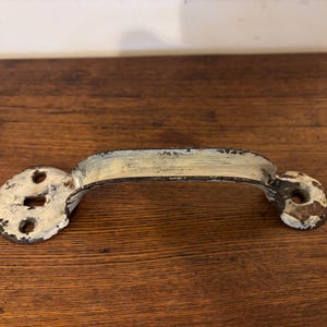 May include: A handmade wooden sign with the text "Welcome" in a playful font. The sign features a distressed white background and a dark brown frame, perfect for a front door or entryway.