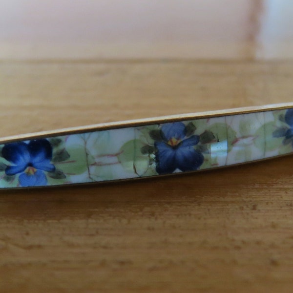 Vintage enamel pin with blue pansies.