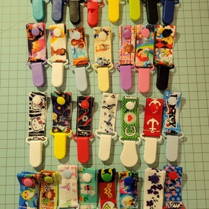 Tubie Clips in Boy & Girl prints, specify. 6 clips for 13.00.  Pick your print. Discontinued button embellishments on clips.