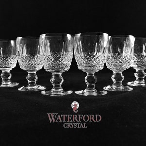 May include: Set of six Waterford crystal glasses with a diamond pattern. The glasses are clear and have a stemmed base.