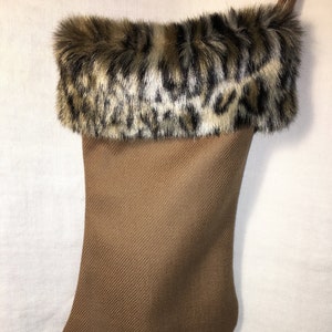May include: A brown stocking with a faux fur cuff featuring a leopard print pattern.