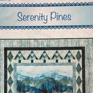 May include: A quilt pattern titled Serenity Pines, PTN2679, BTBQ204, Bound to Be Quilting. The design features a central landscape of mountains and pine trees in shades of blue and green, framed by a border of diamond shapes and stylized pine trees.