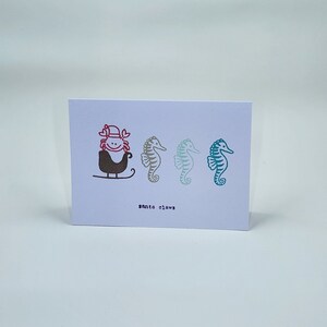 Carte de vœux de Noël - crabe à pinces de sable et hippocampes sur le thème de l’océan