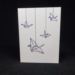 carte de vœux - grues en papier suspendue