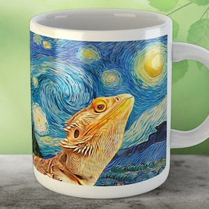 May include: White ceramic mug with a handle. The mug features a colorful image of a bearded dragon against a blue and yellow starry night sky background.