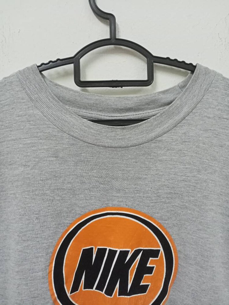 May include: A white ceramic mug with a black handle and the text "But First, Coffee" in a handwritten style. The mug is on a white surface. The mug is 4 inches tall.