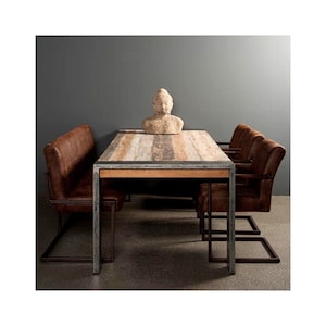 May include: A rustic wooden dining table with a metal frame and four brown leather chairs. A small stone sculpture sits on the table.