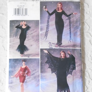 May include: A Butterick sewing pattern package, P246, featuring images of women in various black costumes. The costumes include a long dress with sheer sleeves, a dress with batwing sleeves, and a red dress with long sleeves. The package has a barcode and text.