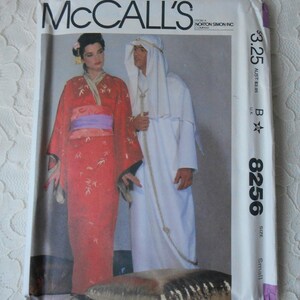 May include: A sewing pattern for a red and white kimono and a white robe. The pattern is from McCall's and is size small. The pattern number is 8256.