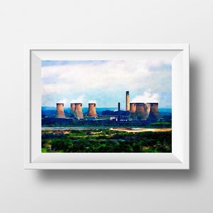 May include: A framed watercolor print of an industrial landscape featuring cooling towers and smokestacks. The artwork depicts a power plant with a green foreground, blue water, and a cloudy sky. The print is in a white frame.