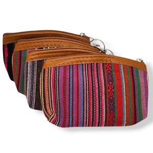 May include: Three colourful striped fabric pouches with brown leather trim and zipper closures.