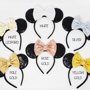 May include: Set of ten black sequin Minnie Mouse ears headbands with different colored bows. The bows are white, silver, rose gold, pale gold, and yellow gold.