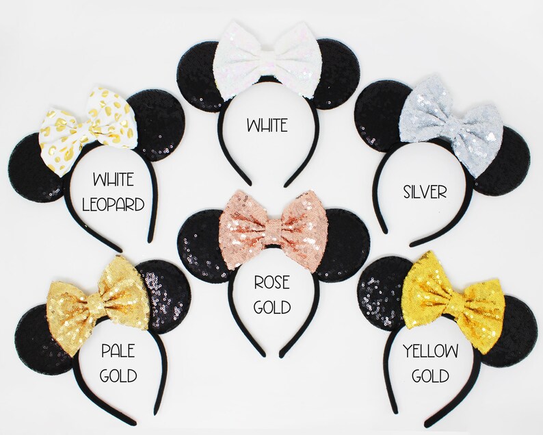 May include: Set of ten black sequin Minnie Mouse ears headbands with different colored bows. The bows are white, silver, rose gold, pale gold, and yellow gold.