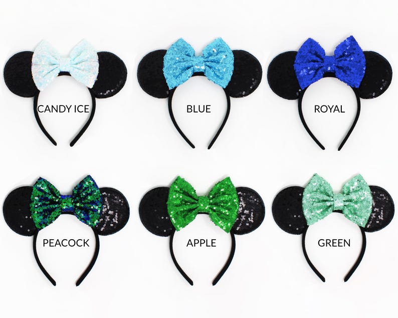 May include: Six headbands with black sequin ears and colorful sequin bows. The bows are labeled Candy Ice, Blue, Royal, Peacock, Apple, and Green. Each headband features a thin black band and two round ears covered in black sequins.