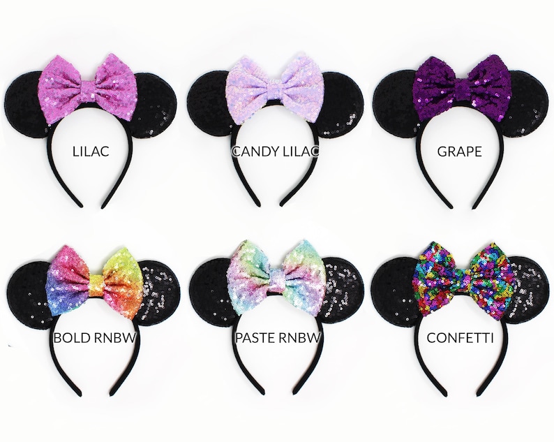 May include: Six headbands with black sequin ears and bows in various colors. The bows are labeled LILAC, CANDY LILAC, GRAPE, BOLD RNBW, PASTE RNBW, and CONFETTI. Each headband features a thin black band and a central sequined bow.