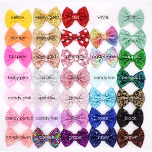 May include: A collection of thirty-five decorative bows arranged in a grid, featuring various colors, textures, and patterns including sequins, glitter, and solid fabrics. Each bow is labeled with its corresponding color name, such as yellow, red, mint, gold, silver, black, and brown, displayed in a clear, sans-serif font.