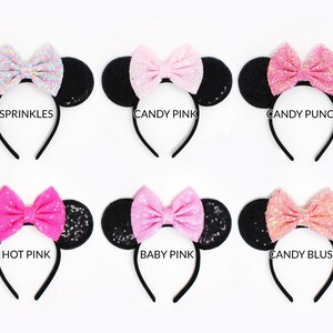 May include: Six black sequined mouse ear headbands with colorful bows labeled Sprinkles, Candy Pink, Candy Punch, Hot Pink, Baby Pink, and Candy Blush. Each headband features round ears covered in black sequins and a central fabric bow.