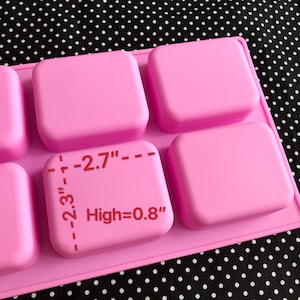 May include: Pink silicone mold with six rectangular cavities for making soap bars. The mold measures 2.7 inches wide by 2.3 inches long and is 0.8 inches high.