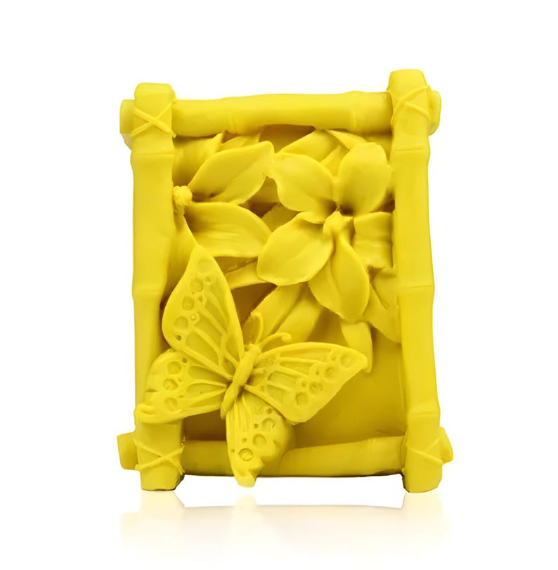May include: Yellow soap bar with a raised design of a butterfly and flowers in a bamboo frame.
