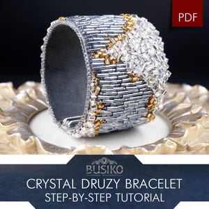 May include: A crystal druzy bracelet tutorial. The cuff bracelet features silver and gold beads with a clear crystal design. The bracelet is displayed on a decorative gold plate. The text "Crystal Druzy Bracelet Step-by-Step Tutorial" is visible.