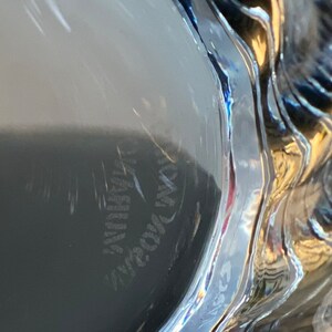 May include: Close-up of the bottom of a clear glass with the words "Made in USA" etched into the glass.