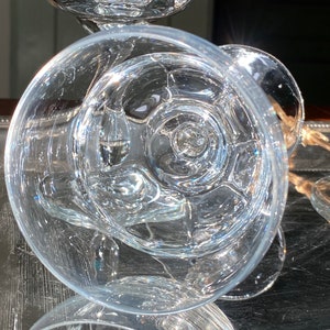 Pu&ograve; includere: Bicchieri di vetro trasparente con un design strutturato unico. Il vetro presenta un motivo a spirale nella coppa ed &egrave; posto su un vassoio d'argento. I bicchieri sono eleganti e adatti per servire bevande.