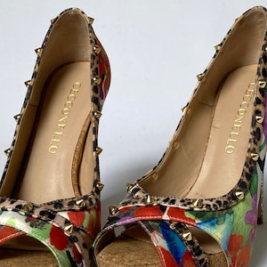 Striking and colorful shoes on high heels 10 cm. Trimmed with leopard print with brass cones. Manufacturer Cecconello.