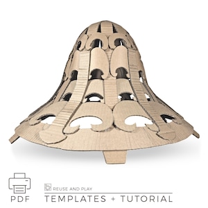 May include: A brown cardboard lampshade with a unique, layered design. The lampshade has a bell-like shape with decorative cutouts. The base is flat with a small rectangular support. The image includes the text "PDF" and "TEMPLATES + TUTORIAL".