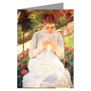 May include: Greeting card featuring a painting of a woman in a white dress, seated and knitting. The artwork has a soft, impressionistic style with a palette of greens, reds, and whites. The background shows a garden setting with flowers.