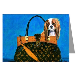 May include: An artistic painting of a Cavalier King Charles Spaniel dog peeking out of a designer handbag. The handbag is black with a gold pattern and brown accents, set against a textured blue background.