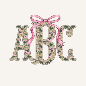 May include: Illustration of the letters "ABC" in a camouflage pattern of green, pink, and brown. A pink bow is tied at the top of the letters. The letters have a decorative, ornate font style. The background is a solid, off-white color.