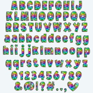 May include: A colorful alphabet with rainbow glitter and a silver outline. The letters are uppercase and lowercase, and there are numbers 0-9 and symbols including ampersand, at sign, exclamation point, question mark, hashtag, period, comma, and a heart.