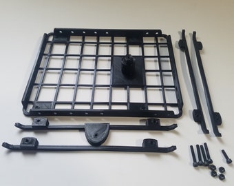 May include: A black 3D printed roof rack kit for a toy car. The kit includes a square roof rack, two side rails, and hardware.