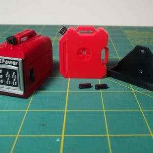 May include: Two red plastic fuel containers, one with the text "NASPOWER" on the front, and a black plastic mounting bracket.