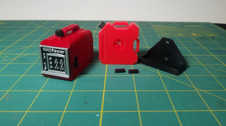 May include: Two red plastic fuel containers, one with the text "NASPOWER" on the front, and a black plastic mounting bracket.