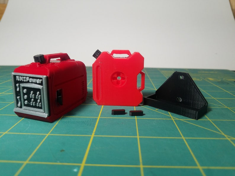 May include: A red plastic model of a small generator with the text "Mini Power" on the front, a red plastic model of a gas can, a black plastic bracket, and two black plastic pieces.